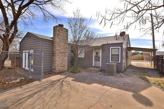 rear view of property with cooling unit