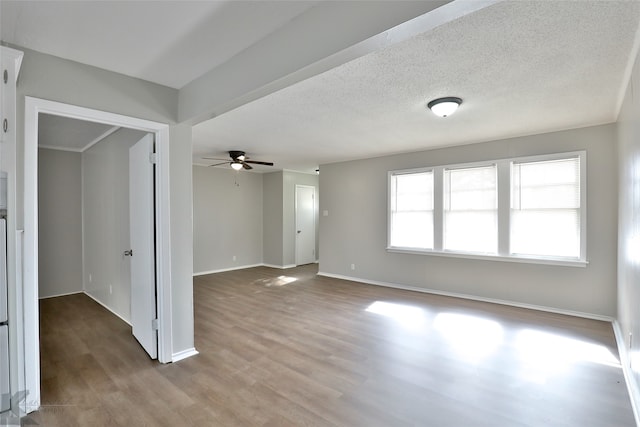 spare room with hardwood / wood-style floors, a textured ceiling, and ceiling fan