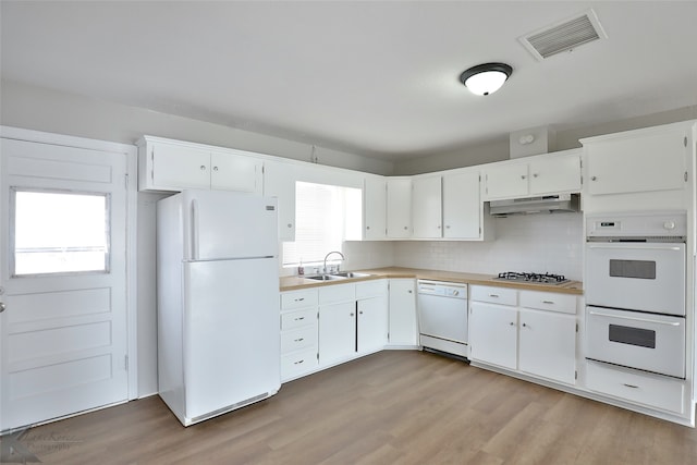 kitchen featuring white cabinetry and white appliances