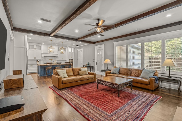 living room featuring beam ceiling, wood-type flooring, and ceiling fan