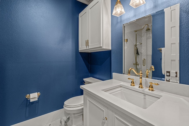 bathroom with toilet, vanity, and a shower