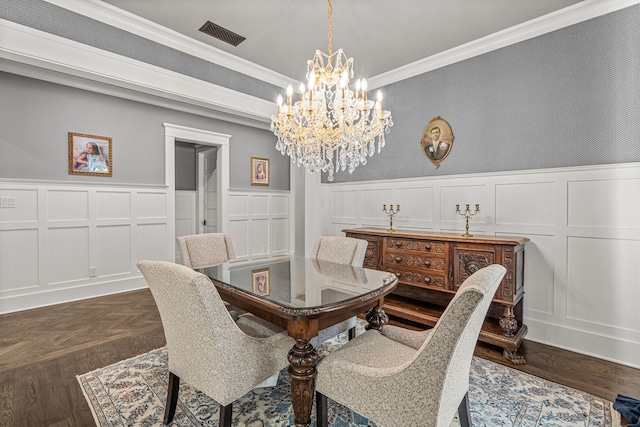 dining area with an inviting chandelier and ornamental molding