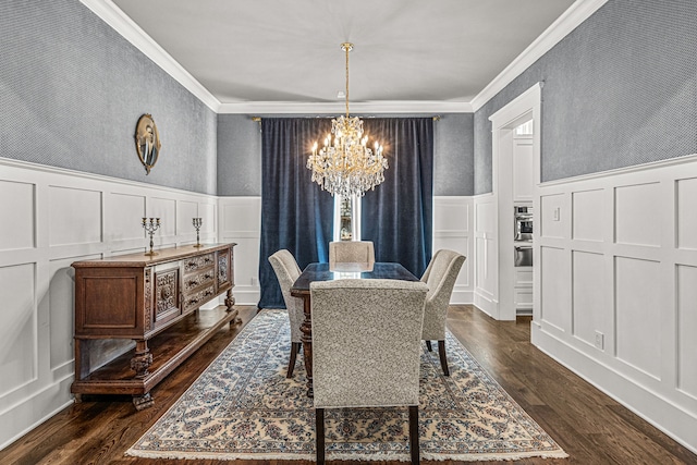 dining room with crown molding, dark hardwood / wood-style floors, and a chandelier