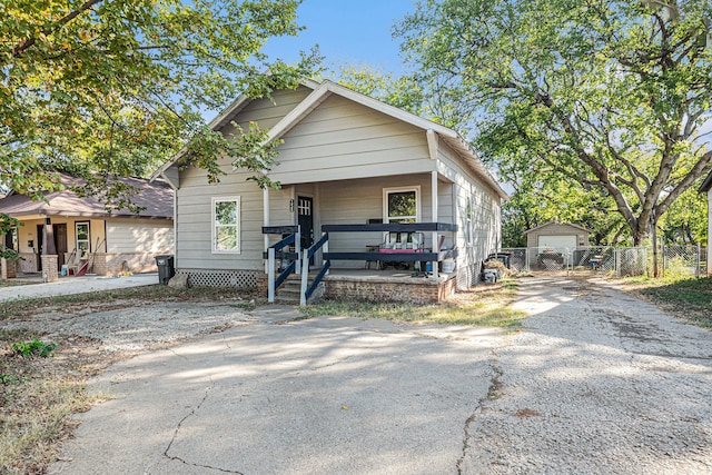 bungalow with covered porch and a garage