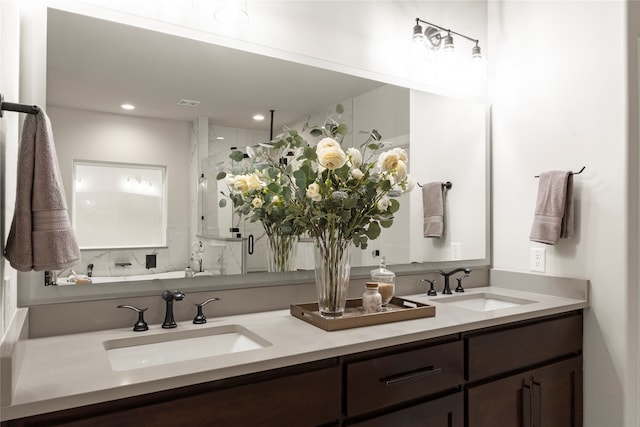 bathroom featuring vanity, a shower with door, and tasteful backsplash