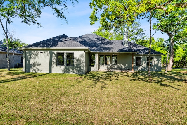 back of house with a yard