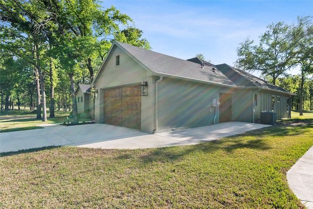 garage featuring cooling unit and a yard