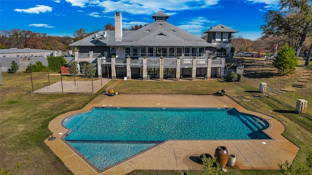 view of pool featuring a lawn and a patio area