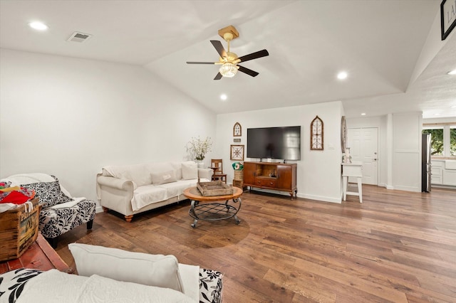 living room with ceiling fan, lofted ceiling, and hardwood / wood-style flooring