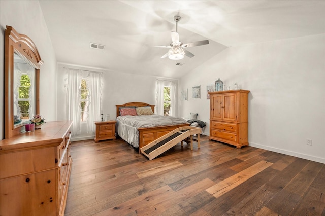 bedroom with ceiling fan, dark wood-type flooring, and vaulted ceiling