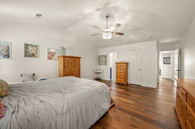 bedroom with ceiling fan, dark hardwood / wood-style floors, and lofted ceiling