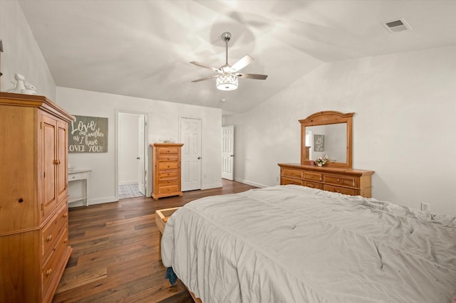 bedroom with ceiling fan, vaulted ceiling, and dark wood-type flooring