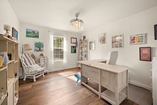 home office featuring an inviting chandelier and hardwood / wood-style floors