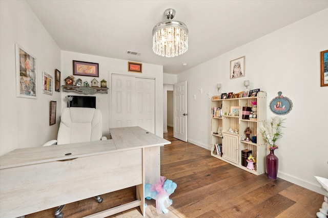 bedroom featuring dark hardwood / wood-style floors and a notable chandelier