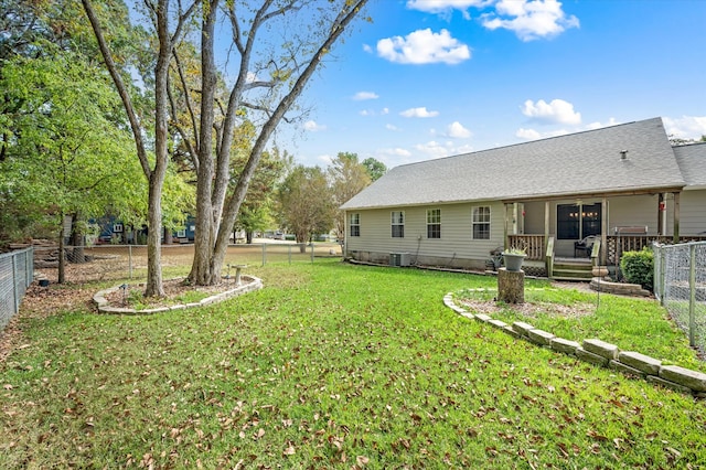 view of yard featuring a deck and central AC