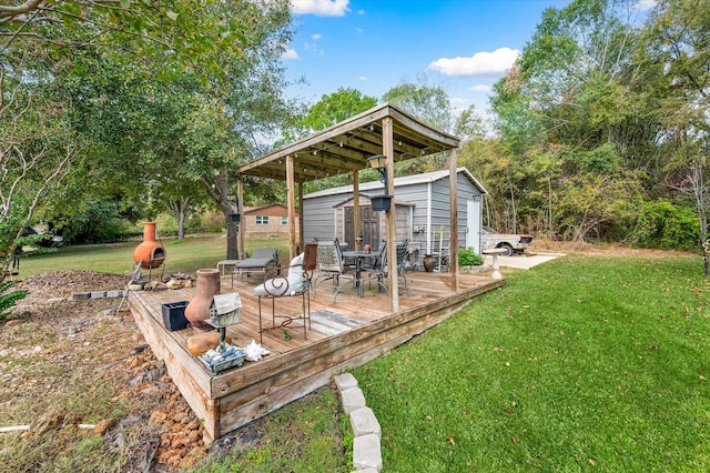 view of yard featuring a wooden deck and a storage unit