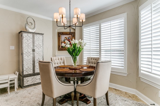 dining area with ornamental molding, a healthy amount of sunlight, and a notable chandelier