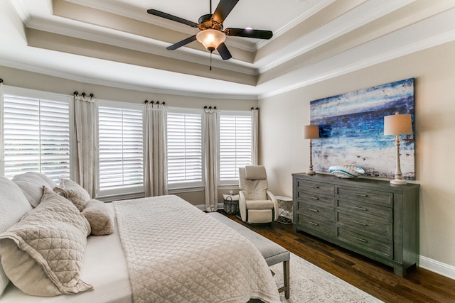 bedroom featuring ceiling fan, dark hardwood / wood-style floors, a raised ceiling, and ornamental molding