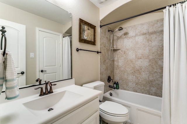 full bathroom with vanity, shower / bath combination with curtain, and toilet