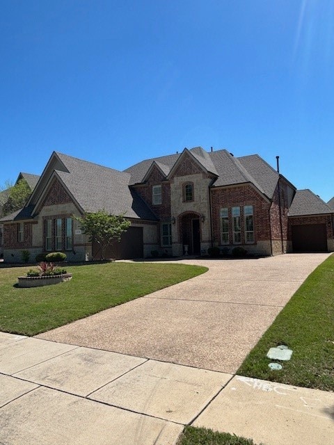 view of front of property featuring a front yard and a garage