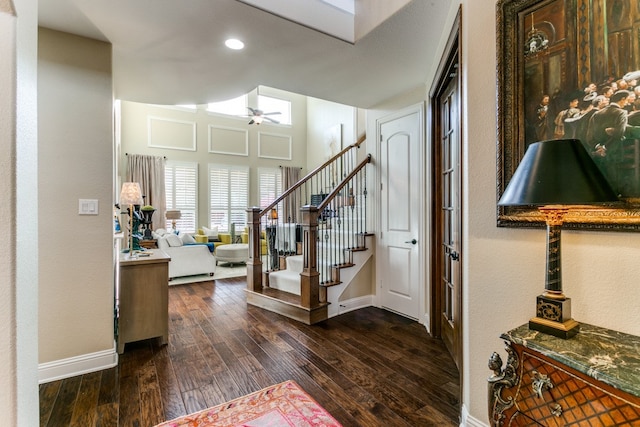 foyer entrance with dark hardwood / wood-style flooring and ceiling fan