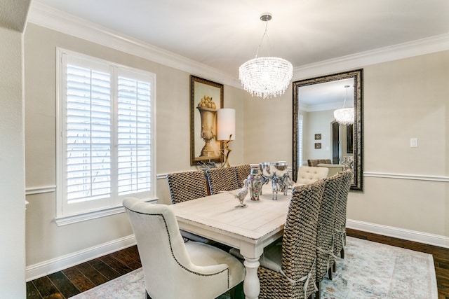 dining room featuring dark hardwood / wood-style flooring, an inviting chandelier, and crown molding