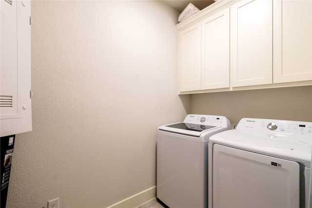 laundry area with cabinets and separate washer and dryer