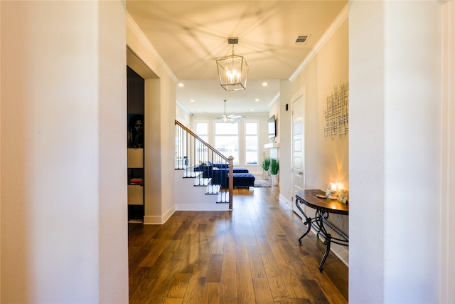 hall with ornamental molding, a chandelier, and dark hardwood / wood-style flooring