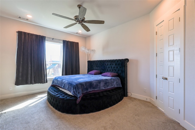 bedroom featuring ceiling fan and light colored carpet