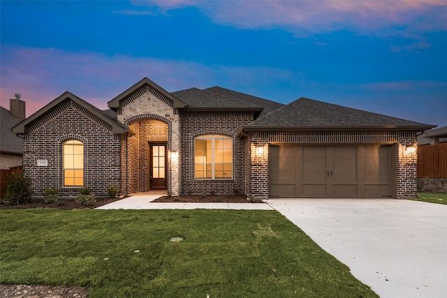 french country inspired facade with a garage and a lawn