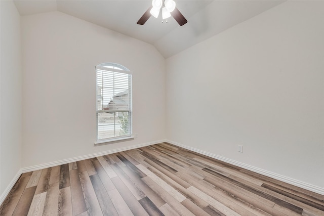 spare room with lofted ceiling, ceiling fan, and light wood-type flooring