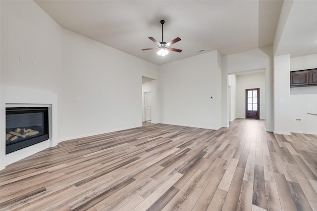 unfurnished living room with ceiling fan and light wood-type flooring