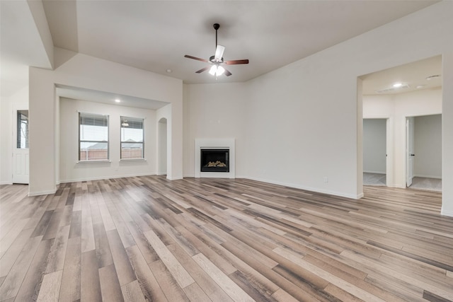 unfurnished living room featuring ceiling fan and light hardwood / wood-style flooring