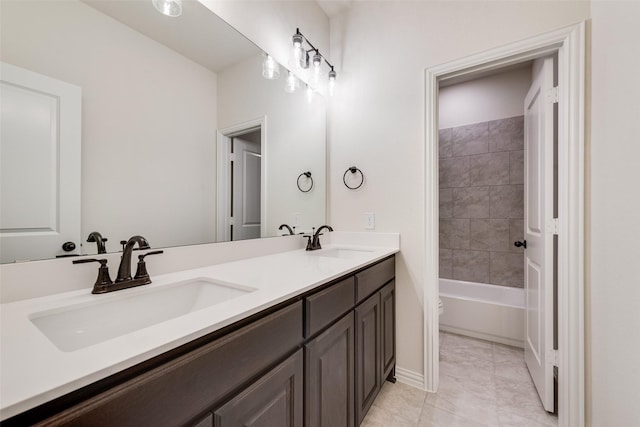 bathroom featuring tiled shower / bath, vanity, and tile patterned floors