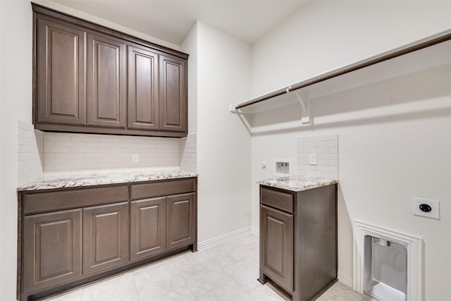 laundry area featuring cabinets, hookup for a washing machine, and hookup for an electric dryer