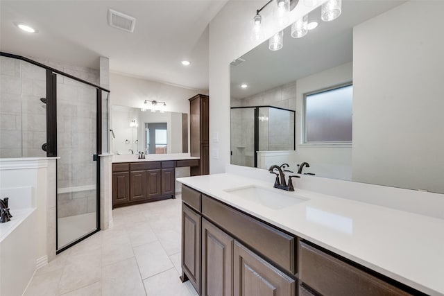 bathroom featuring tile patterned floors, vanity, and a shower with door