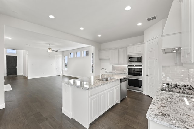 kitchen featuring appliances with stainless steel finishes, sink, white cabinets, and custom range hood