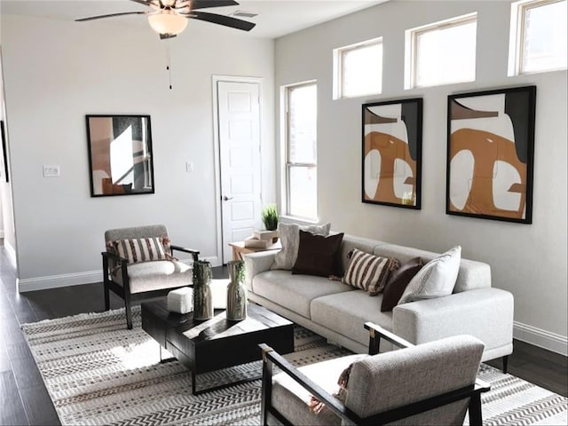 living room with dark hardwood / wood-style floors and ceiling fan