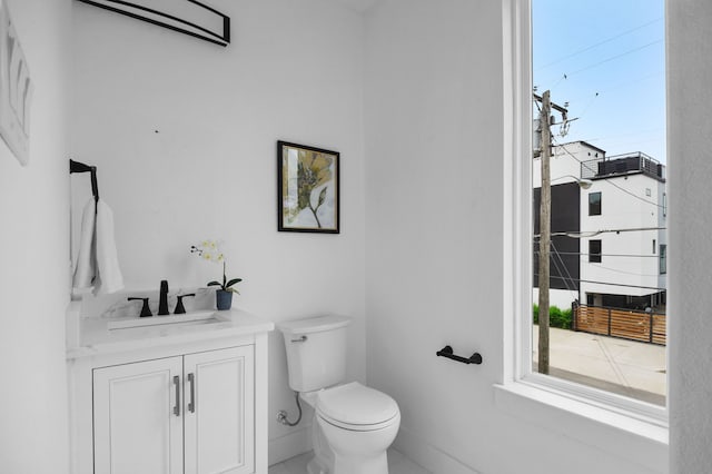 bathroom with a wall mounted air conditioner, vanity, and toilet