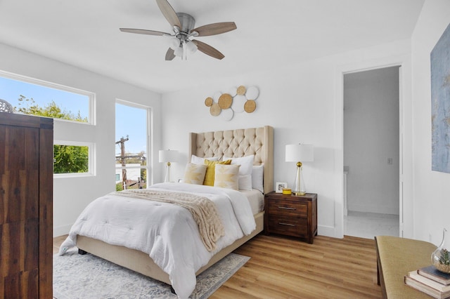 bedroom with light hardwood / wood-style flooring and ceiling fan