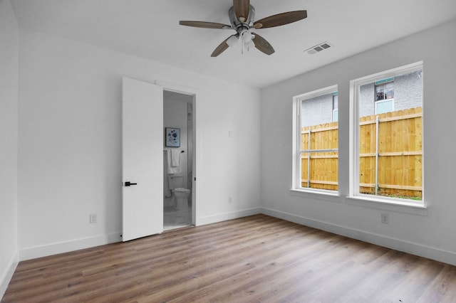 empty room with ceiling fan and light hardwood / wood-style floors