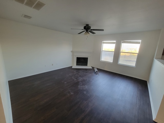 unfurnished living room featuring ceiling fan and dark hardwood / wood-style flooring