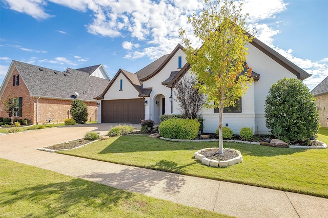 view of front of property featuring a front yard and a garage