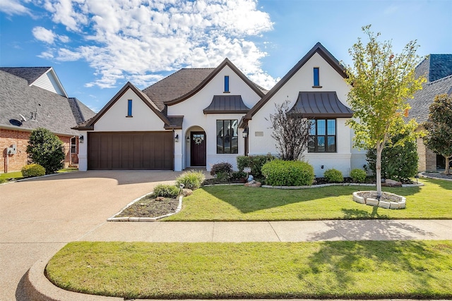 view of front of home featuring a front lawn and a garage