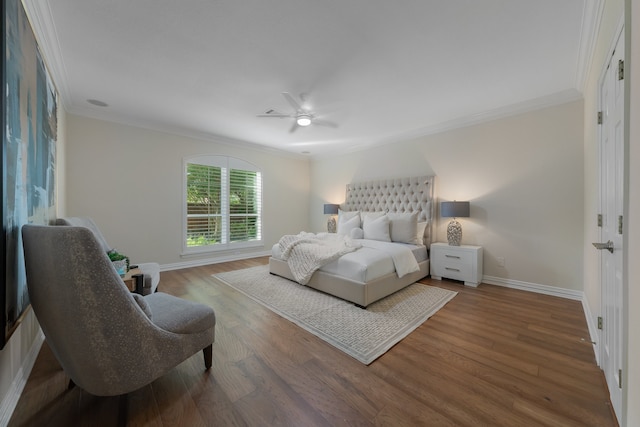 bedroom featuring ceiling fan, hardwood / wood-style flooring, and crown molding