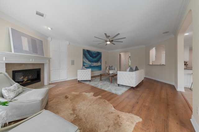 living room with ornamental molding, hardwood / wood-style flooring, and ceiling fan