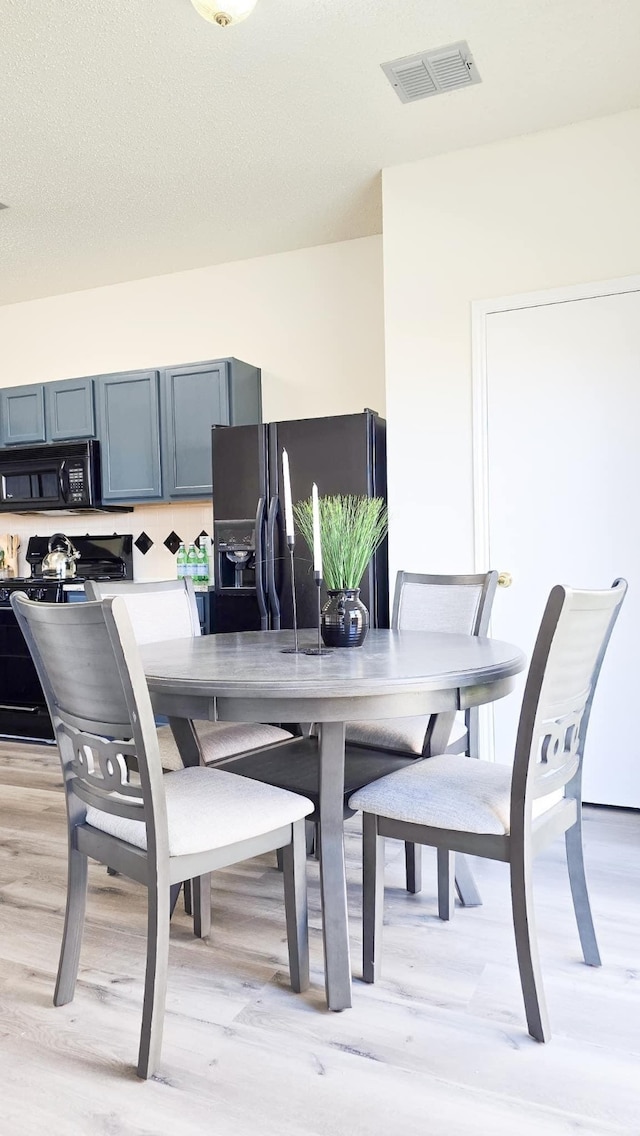 dining space with light hardwood / wood-style flooring