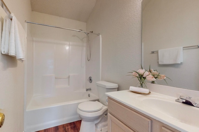 full bathroom featuring a textured ceiling, toilet, vanity, hardwood / wood-style flooring, and shower / bathtub combination