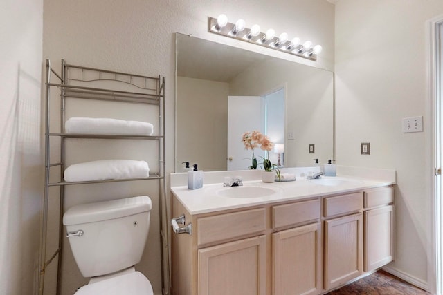 bathroom featuring vanity and toilet