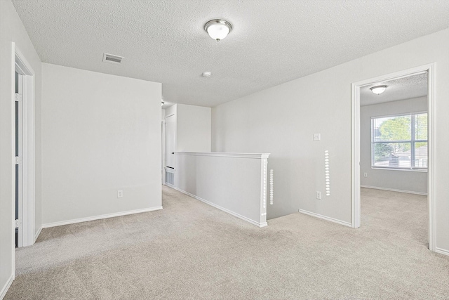 2121 Franks St, Fort Worth, TX 76177 - empty room featuring a textured ceiling, carpet, and baseboards